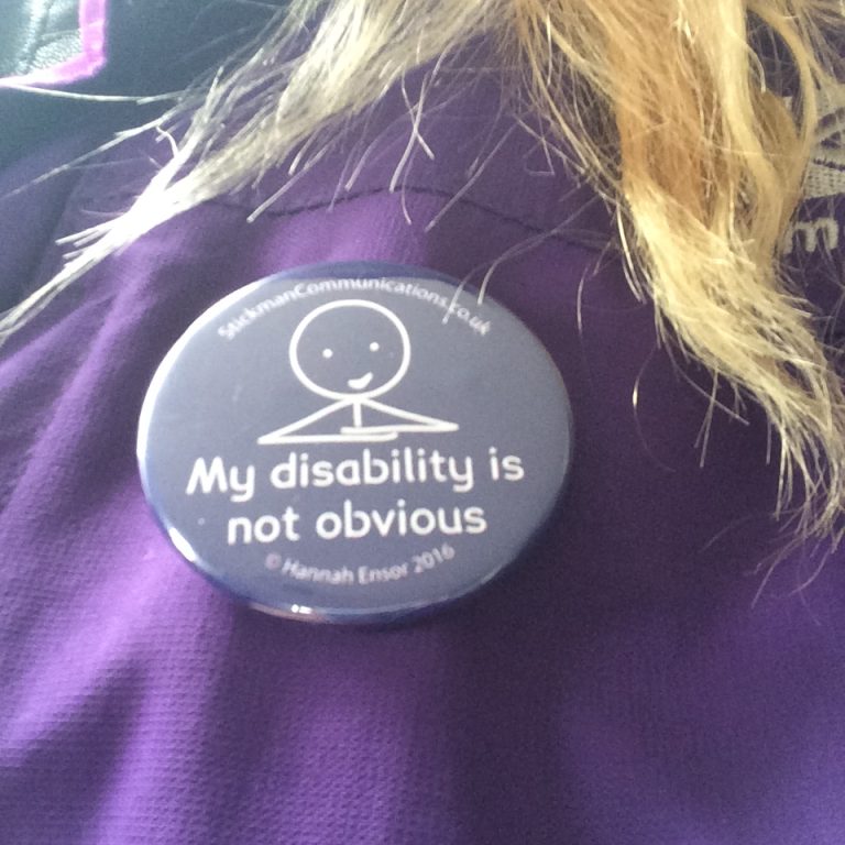 A close-up of a badge which says 'My disability is not obvious' for an article about Invisible Journey