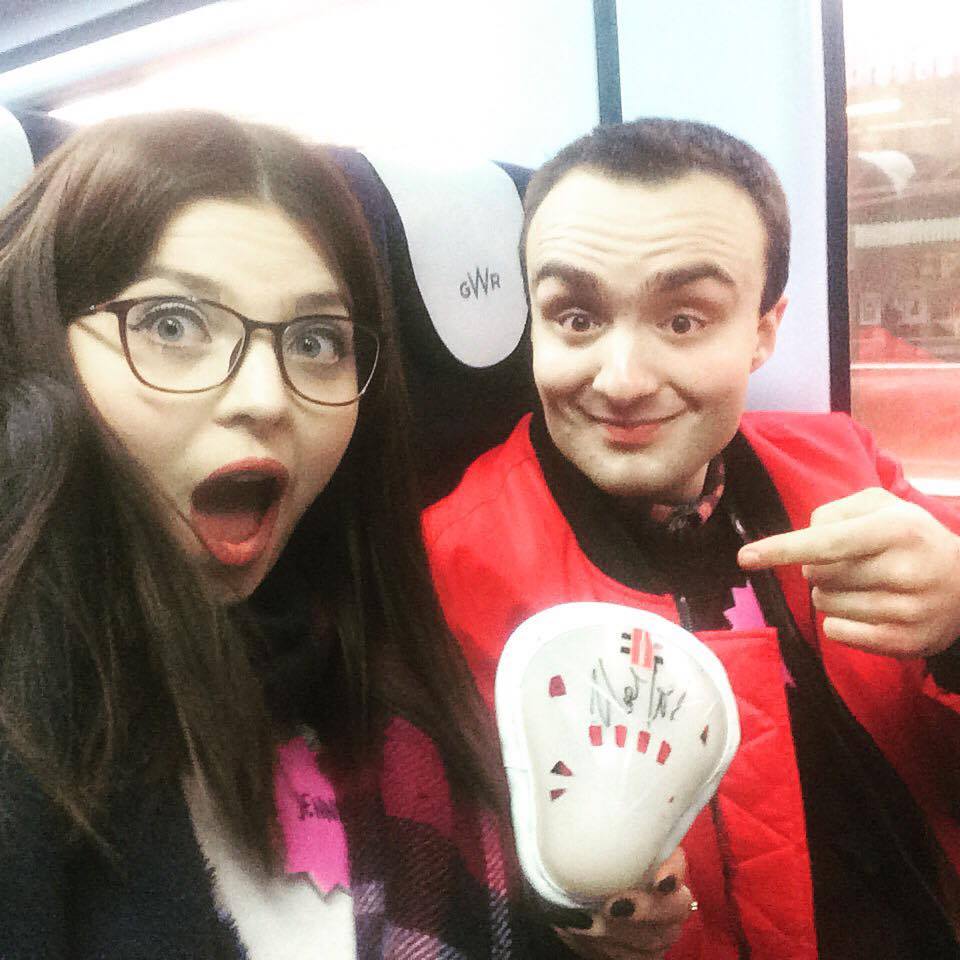 A photo of Jenni and a friend on a train. 