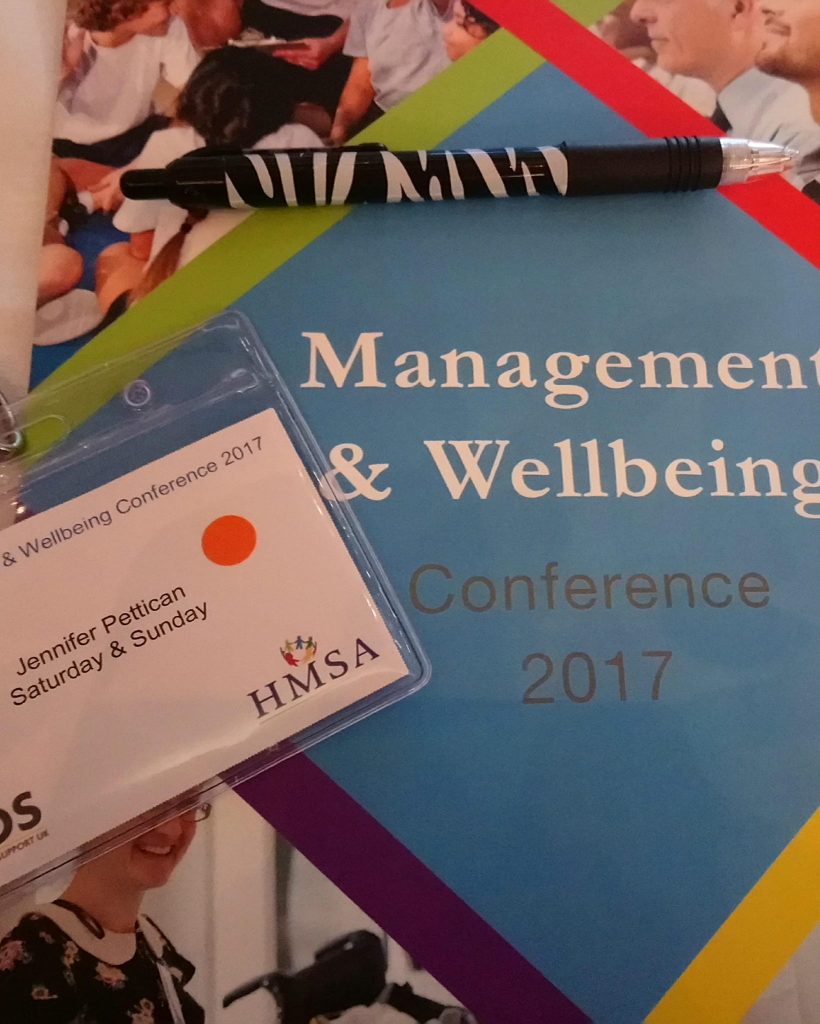 A close up of a conference guide 'Management and Wellbeing'.