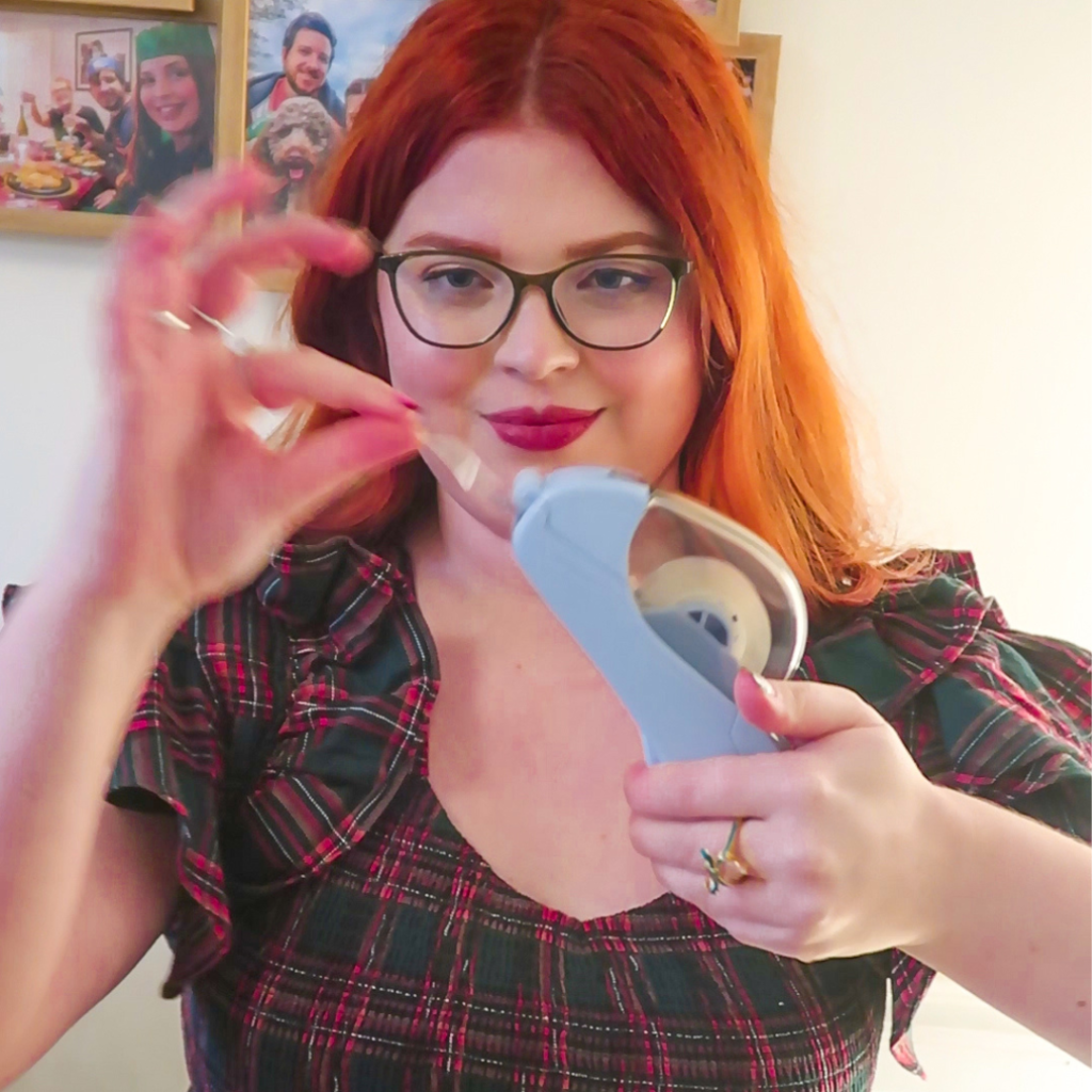 Jenni holding a tape dispenser.