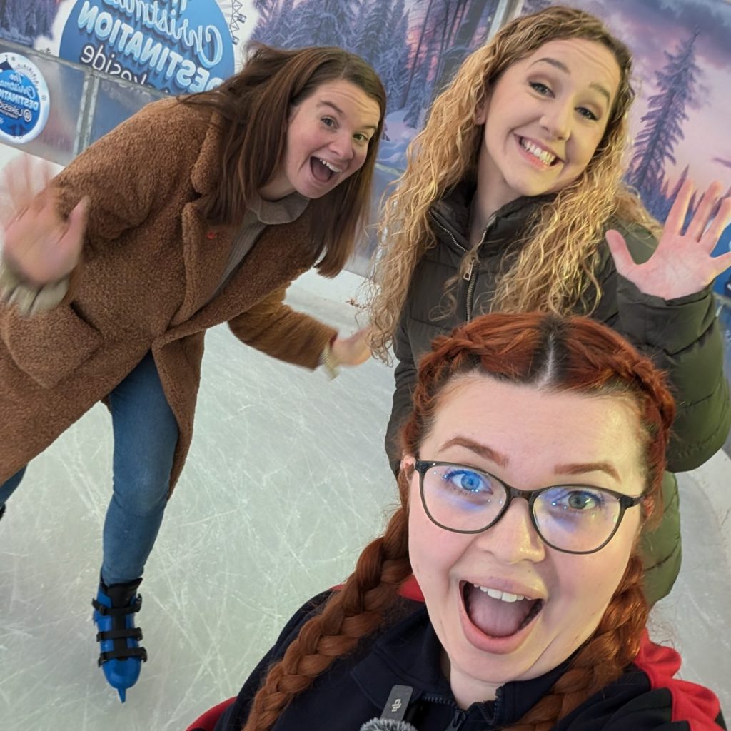 A selfie of Jenni and her support workers Beth & Poppy on an ice skating rink