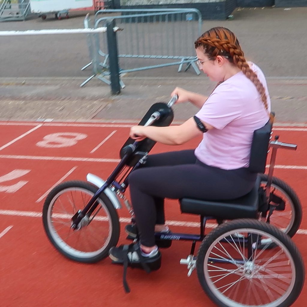 Jenni using a mobility aid to race.