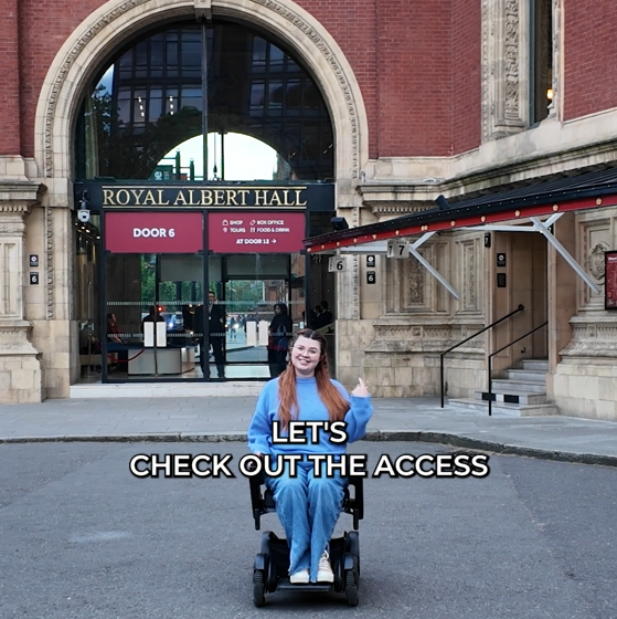 Jenni sat outside the royal albert hall in her powered wheelchair