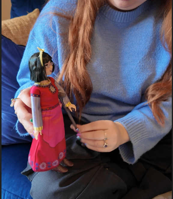 jenni holiding a dahlia doll from wish who uses a crutch