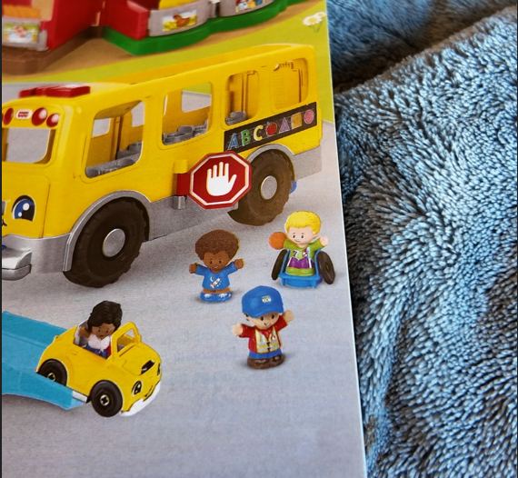 a brochure showing a little people set with a wheelchair basketball player