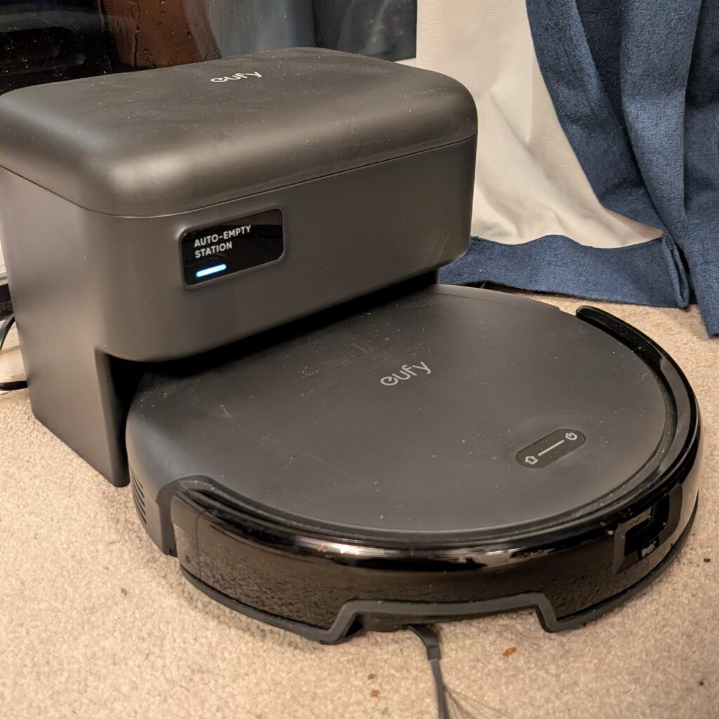 a black automatic emptying robot vacuum cleaner