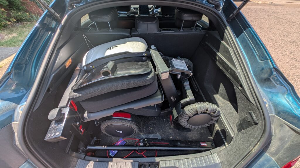 the xsto m4 powerchair folded and in 3 pieces in the boot of Jenni's renault arkana